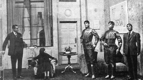 Three actors costumed as robots standing on stage in the 1921 production of R.U.R.
